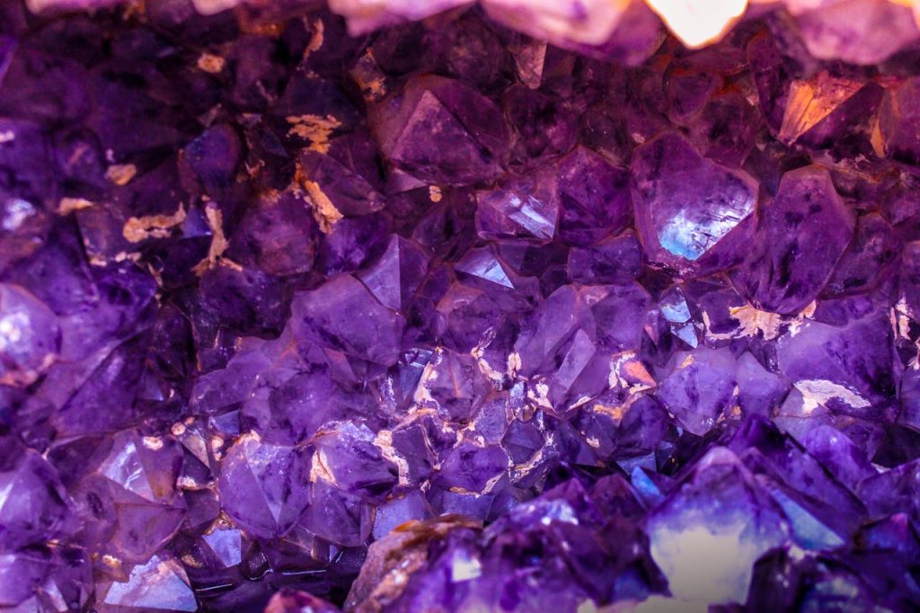 closeup-photo-of-purple-gemstones-1121123 Close-up view of a beautiful amethyst crystal cluster showcasing its vibrant purple hues and natural texture.